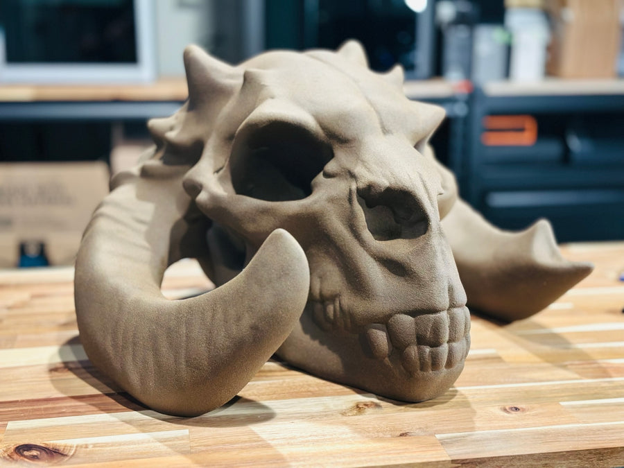 Large horned skull sculpture on the studio workbench
